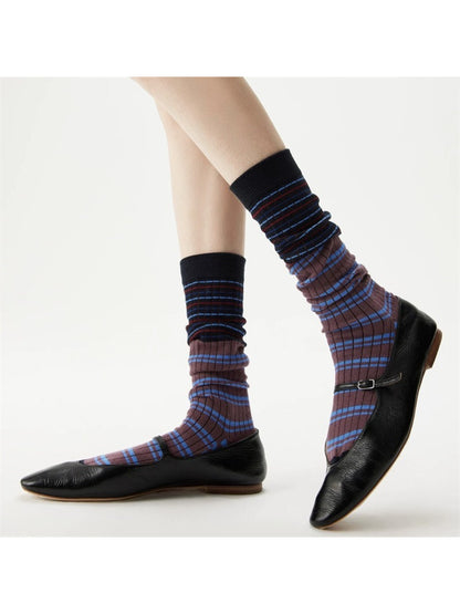 Pair of Rufia crew socks laid flat showing striped pattern and ribbed cuff