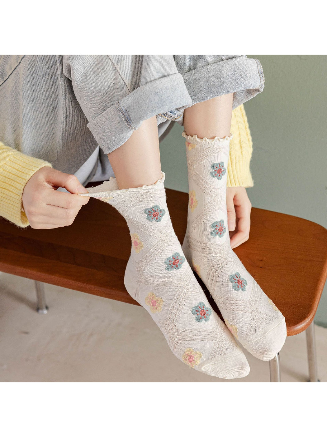 Pair of Rufia soft floral mesh detail crew socks in pastel colors displayed flat