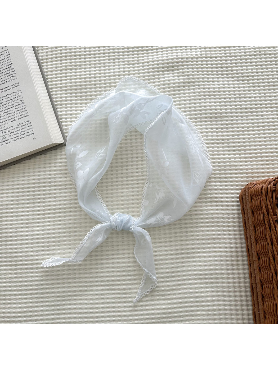 Folded romantic flower triangle scarf displaying soft texture and floral print