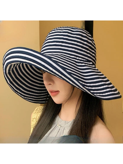 Model wearing Haila striped wide brim sun hat outdoors in sunny setting