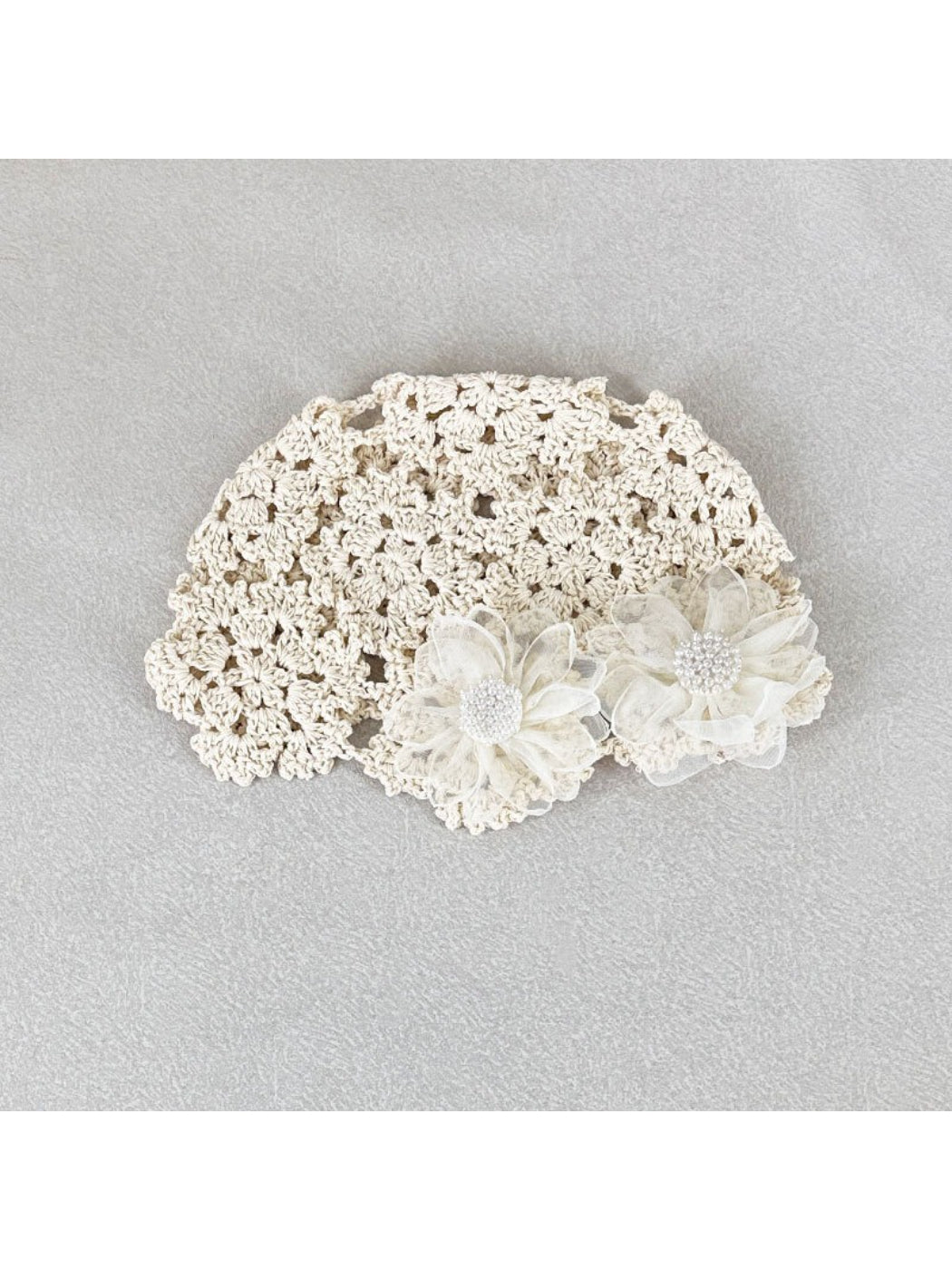 Close-up of flower detail on Haila romantic openwork hat in light beige color