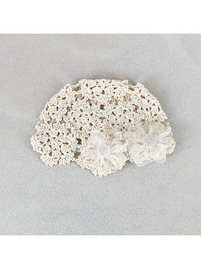 Close-up of flower detail on Haila romantic openwork hat in light beige color