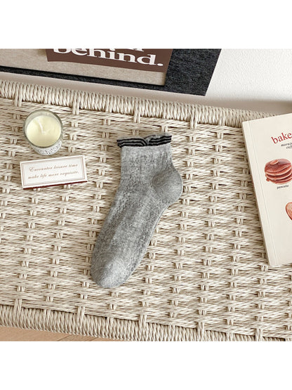 Rufia fine pointelle socks displayed with packaging on a wooden surface