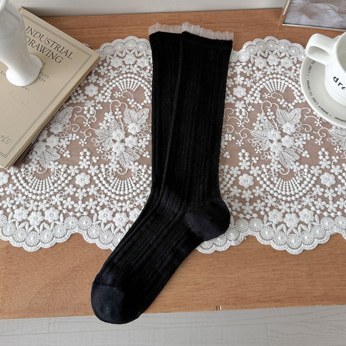 Side view of Rufia beige ribbed crew socks showing stretch and fit