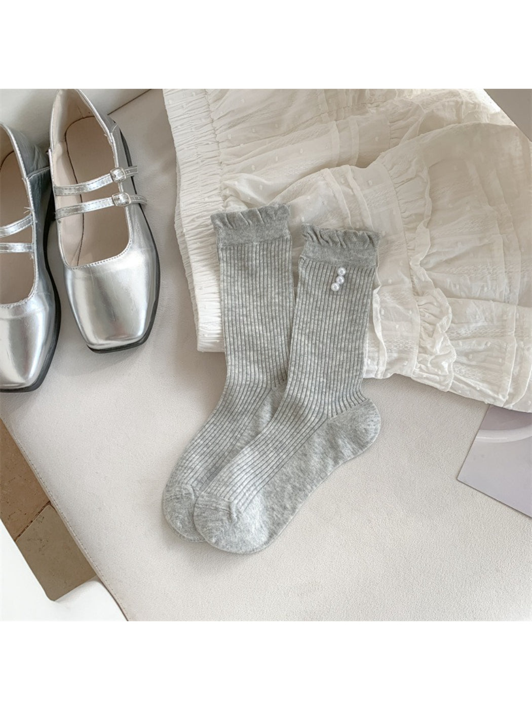 Side view of Rufia beige crew socks highlighting ribbed fabric and trim