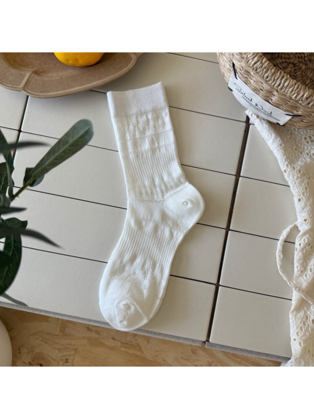 Pair of Rufia Dot Floral mid-calf socks displayed side by side