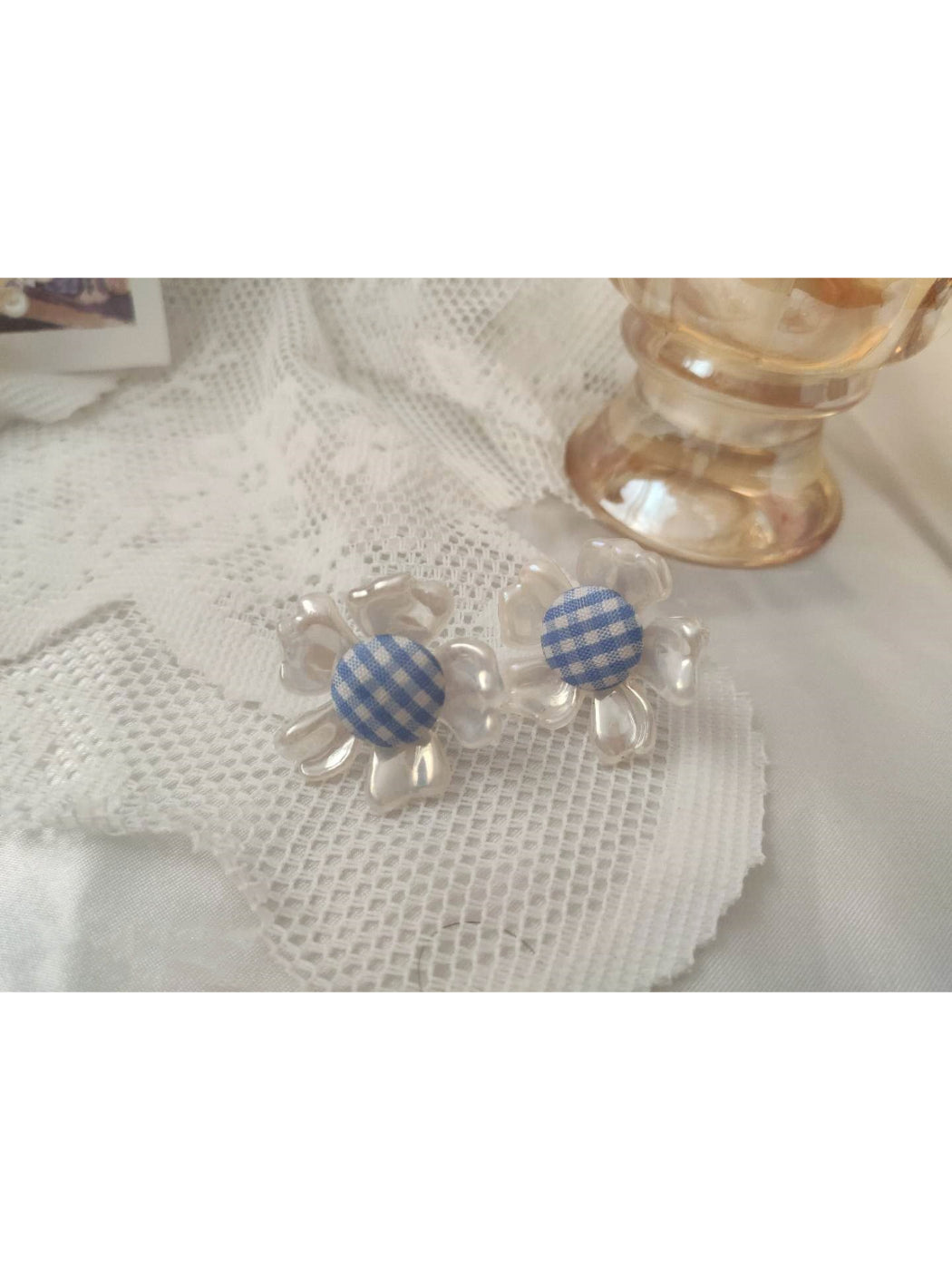 Pair of Earwish gingham flower stud earrings displayed on a white background