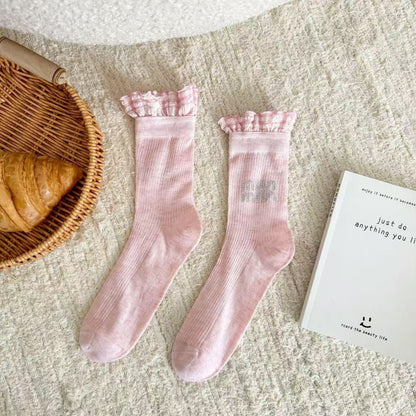 Side view of Rufia pastel mid-calf socks featuring subtle ruffle edge