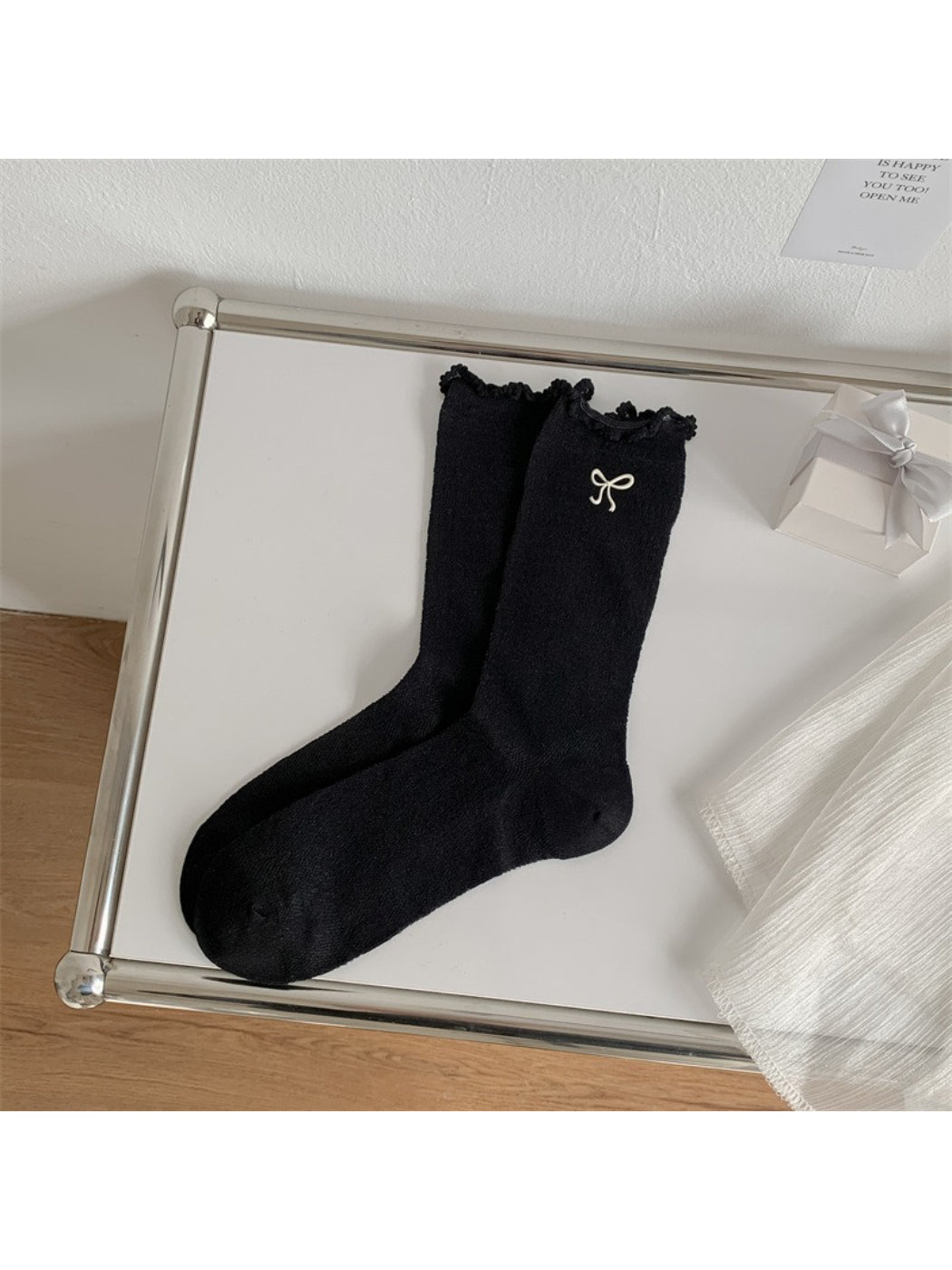 Rufia socks folded to show bow embellishment and lettuce edge design