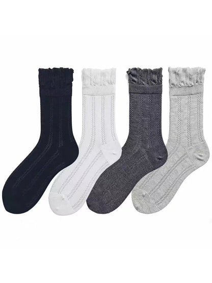 Pair of Rufia vintage pointelle crew socks in cream color displayed flat