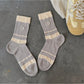 Pair of Rufia colourblock socks with pink, cream, and beige tones