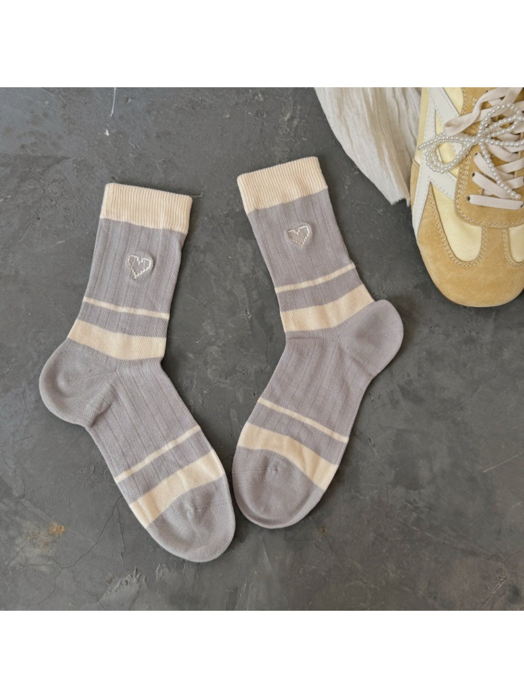 Pair of Rufia colourblock socks with pink, cream, and beige tones