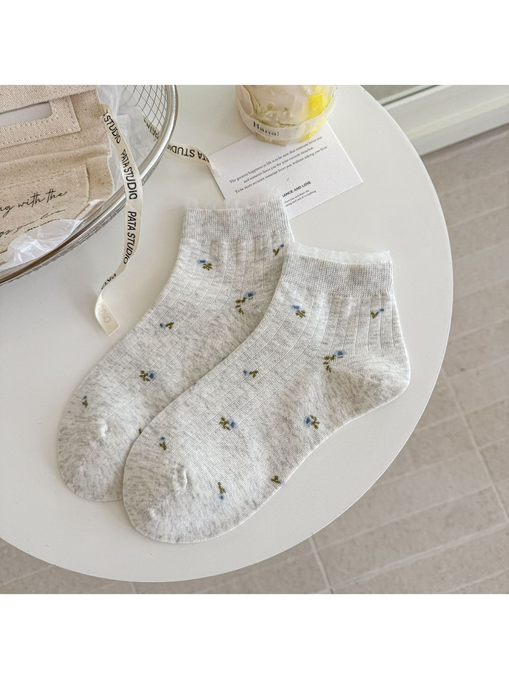 Close-up of ankle cuff with floral lace trim on Rufia soft socks