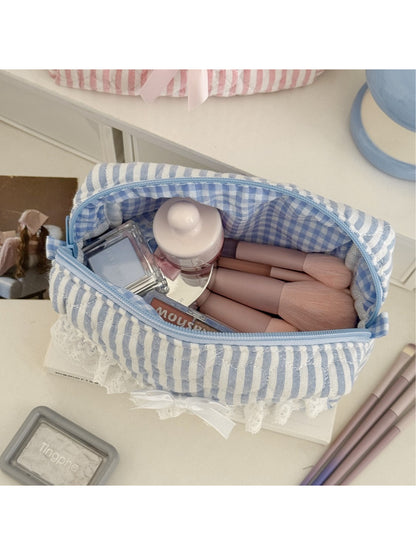Close-up of Cosbai cosmetic pouch showing lace trim and striped fabric