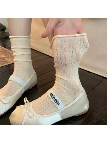 Rufia ribbed mid-calf socks folded neatly in beige tone