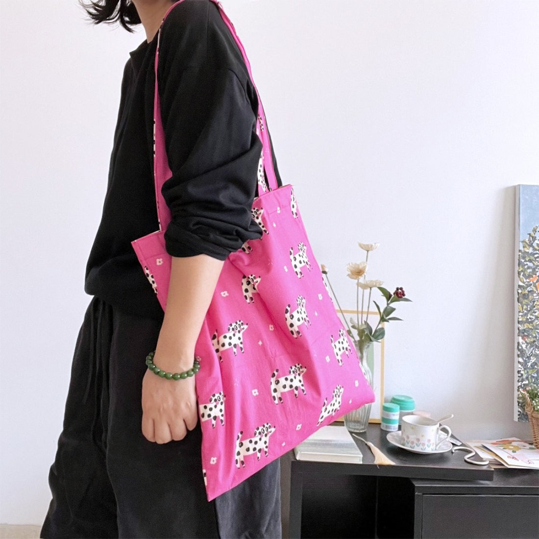 Side view of pink puppy print tote bag showing spacious interior