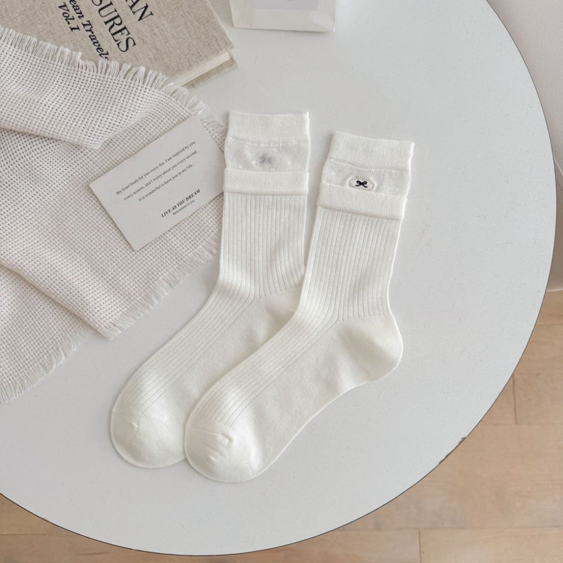 Side view of Rufia beige ribbed socks highlighting cuff and fabric