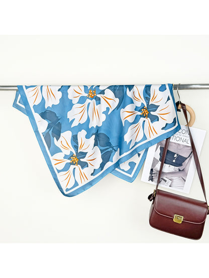 Scarvii Lily Print Square Scarf folded neatly with visible pink lilies and green leaves on white background