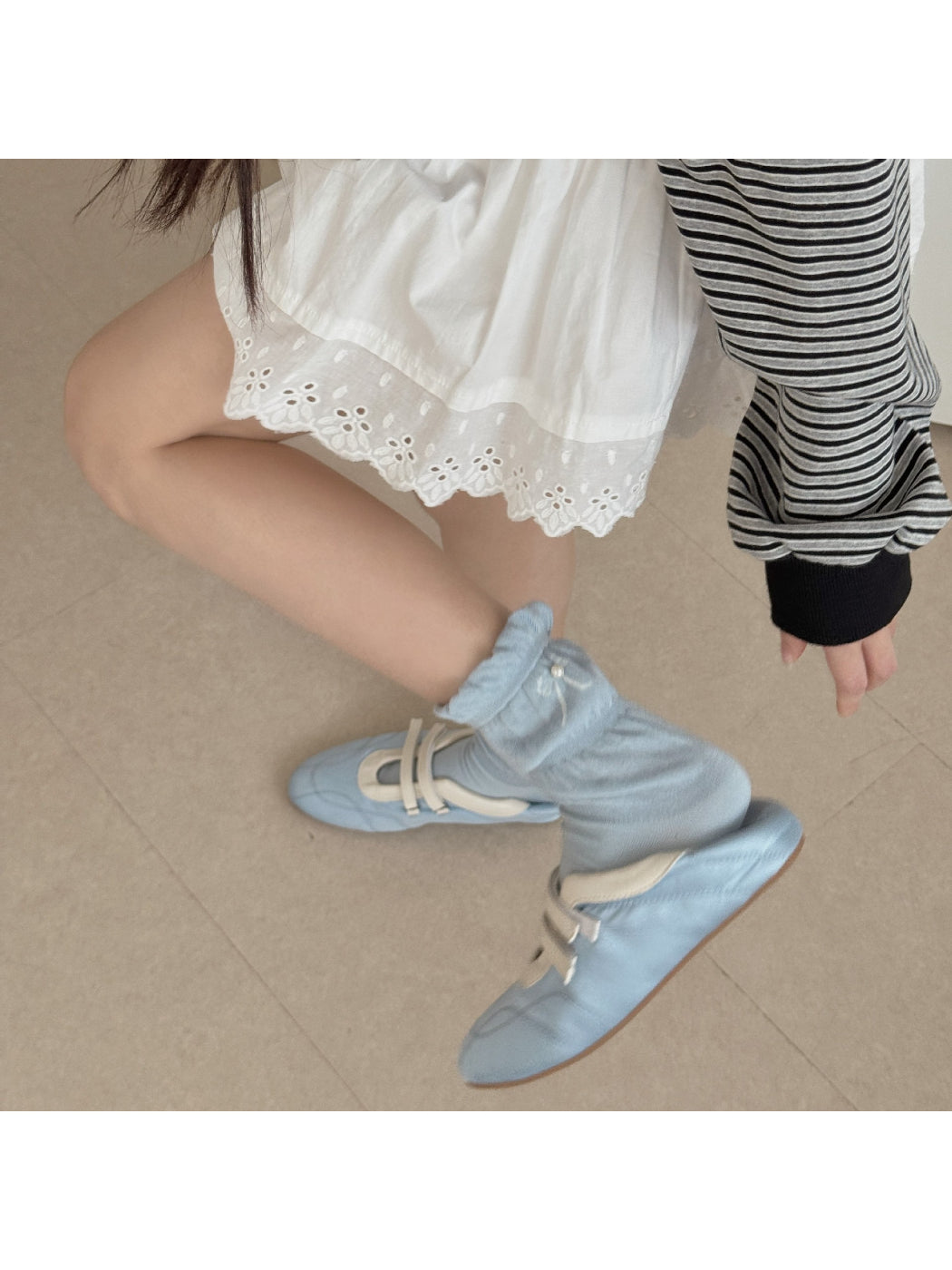 Model wearing Rufia ruffle detail crew socks with casual shoes