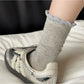 Rufia Pale Bow Everyday Socks worn on feet with visible ribbing