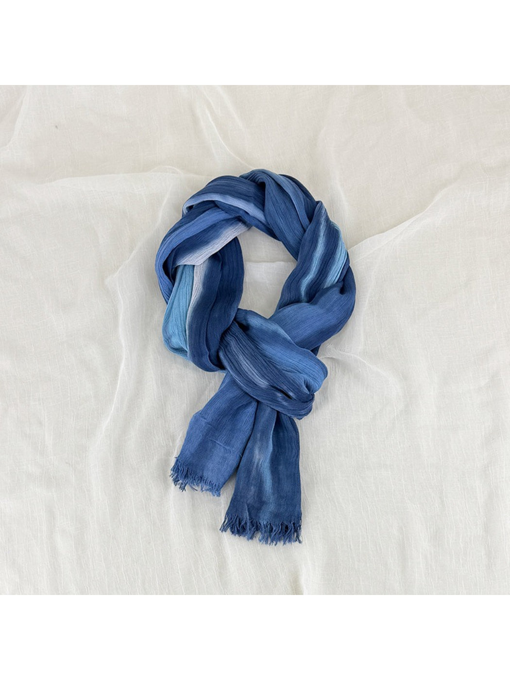 Close-up of Scarvii Painterly Blue scarf fabric texture and frayed edge detail