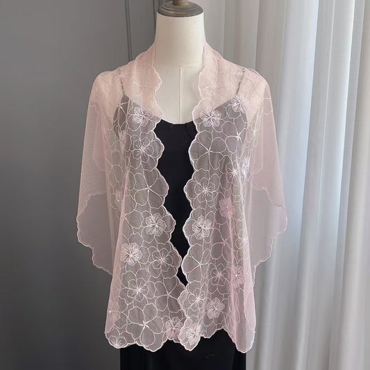 Close-up of floral lace scarf with pearl trim in soft pastel colors