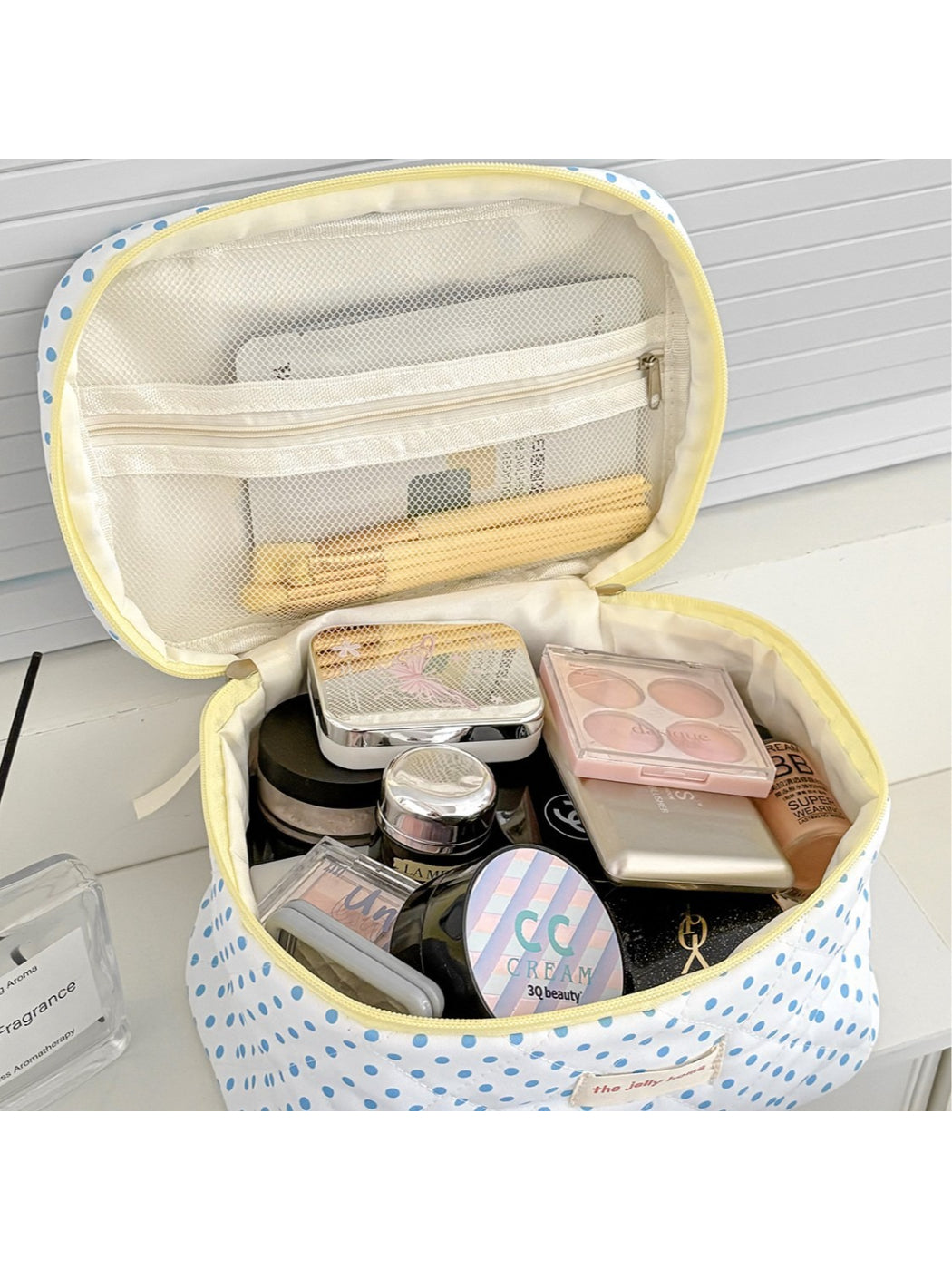 Inside view of Cosbai polka dot quilted cosmetic case showing spacious interior