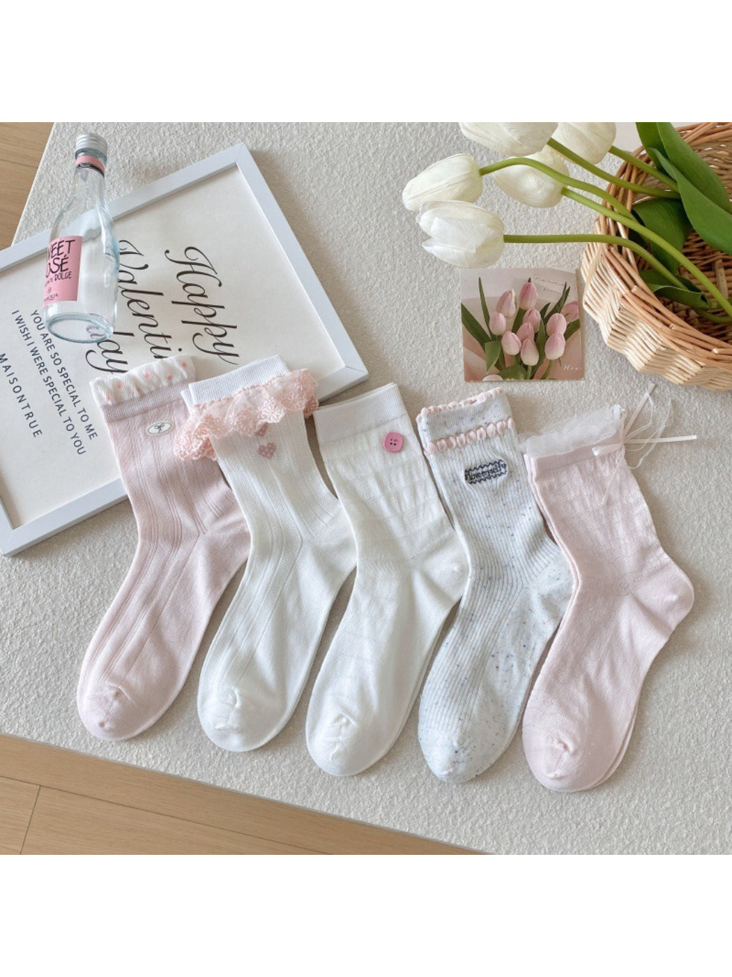 Pair of Rufia soft girly accent crew socks in pastel pink with ribbed cuff