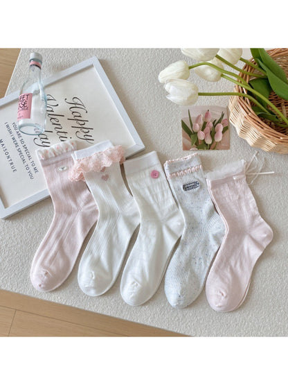 Pair of Rufia soft girly accent crew socks in pastel pink with ribbed cuff