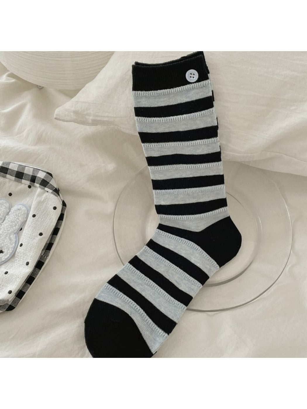 Side view of Rufia crew socks showing button details and horizontal stripes