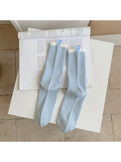 Side view of Rufia crew socks highlighting the contrast stripe and soft material