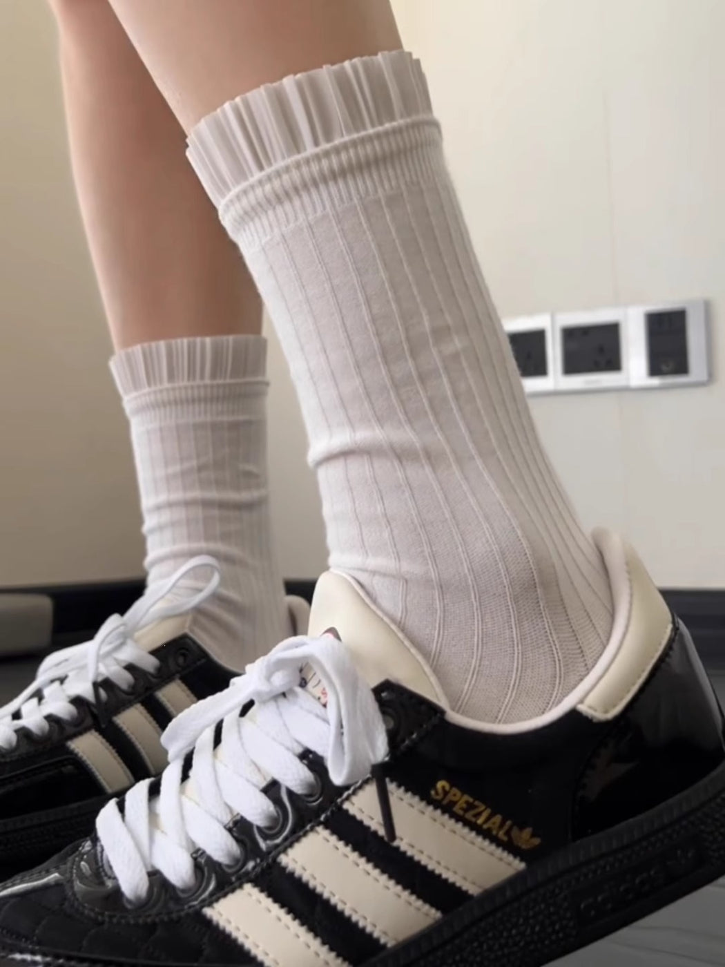 Model wearing Rufia Pleated Cuff Crew Socks standing with feet crossed