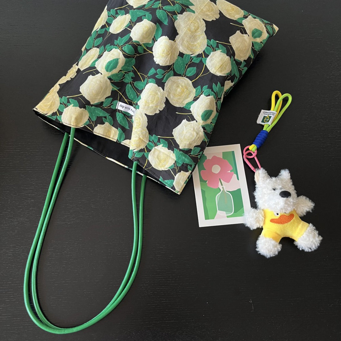 Black rose print shoulder tote bag with green handles