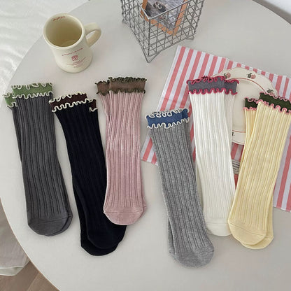Rufia contrast wave trim long socks in black and white, flat lay