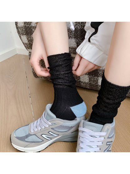 Pair of Rufia cozy crew socks in beige with dark contrast toe detail