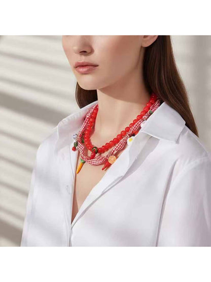 Neckit beaded scarf necklace with charm details displayed flat on white background
