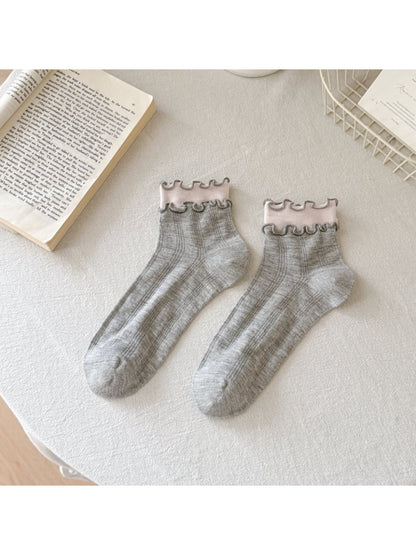 Model wearing Rufia Sweet Frill Edge Ribbed Socks in white with frill edges
