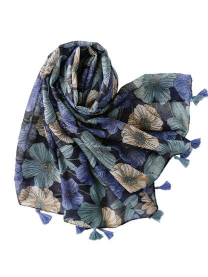 Close-up of Scarvii Garden Bloom Scarf fabric with detailed floral print and tassels
