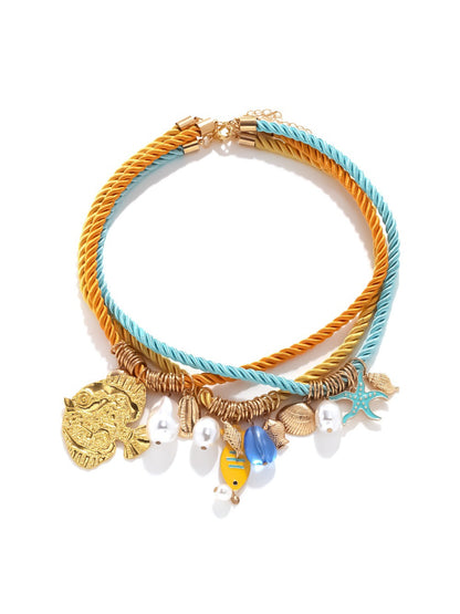 Model wearing the Ocean Charm rope necklace with shell details around the neck