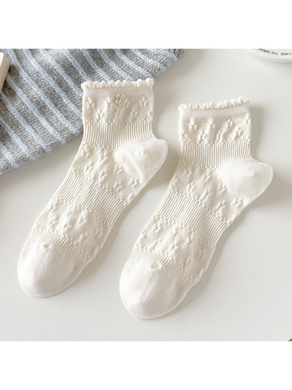 Rufia Sweet Floral Knit Crew Socks worn with rolled-up jeans