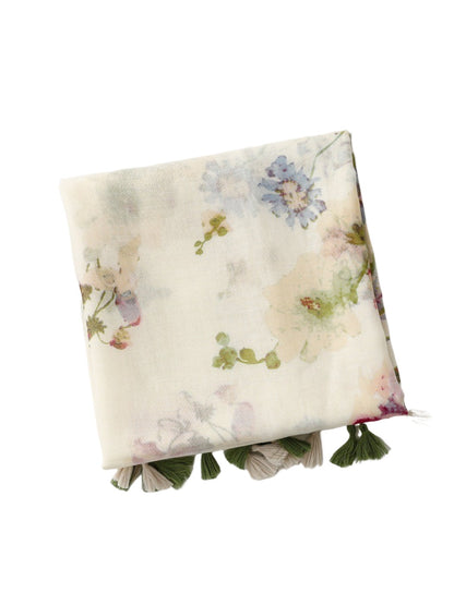 Close-up of Scarvii scarf fabric with detailed watercolor wildflower print and tassel edges