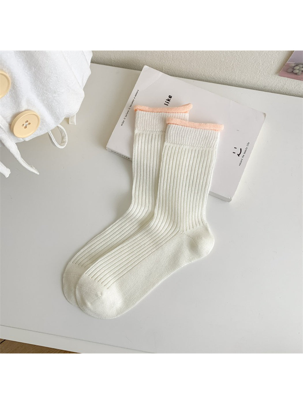 Rufia ribbed crew socks with pastel trim displayed on wooden surface
