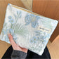 Cosbai blue floral cosmetic bag with a zipper on a white background