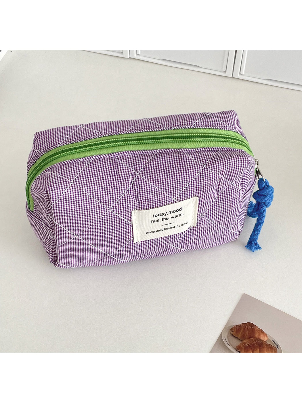 Cosbai cosmetic pouch open with makeup brushes and products inside