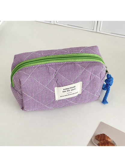 Cosbai cosmetic pouch open with makeup brushes and products inside
