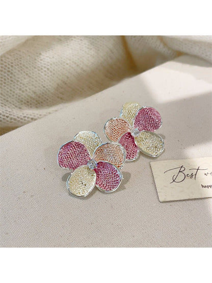 Earwish floral cluster earrings worn on a model's ear showcasing size and fit