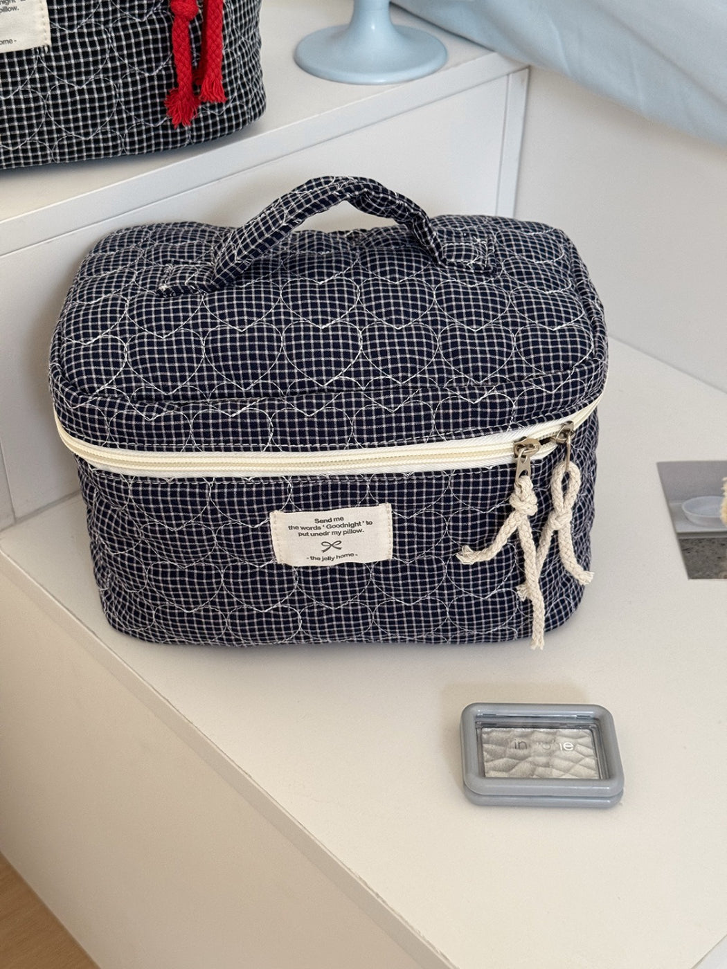 Open view of Cosbai makeup storage case showing organized grid with cosmetics inside