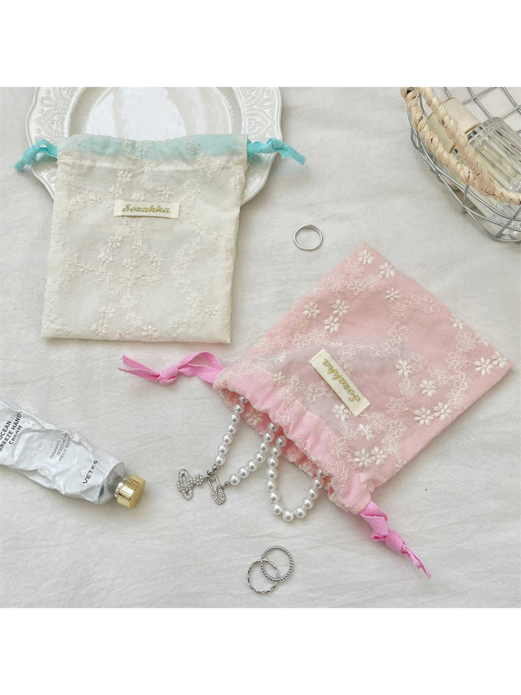 Cosbai floral lace drawstring pouch displayed flat with drawstrings visible
