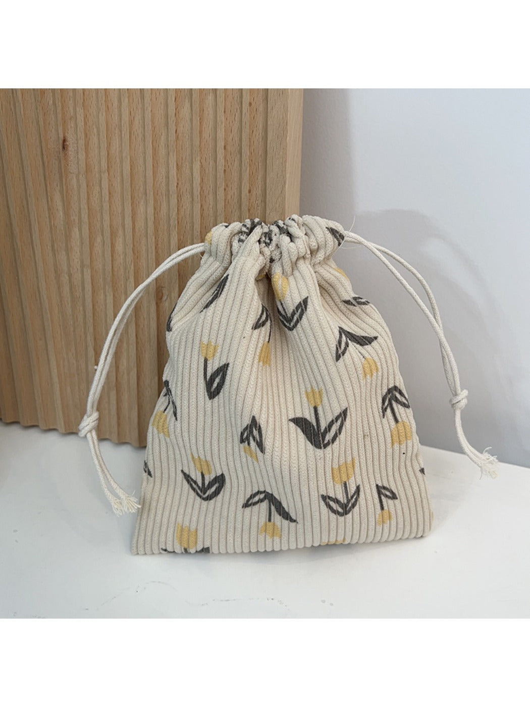 Cosbai floral drawstring pouch shown from side angle highlighting flower print