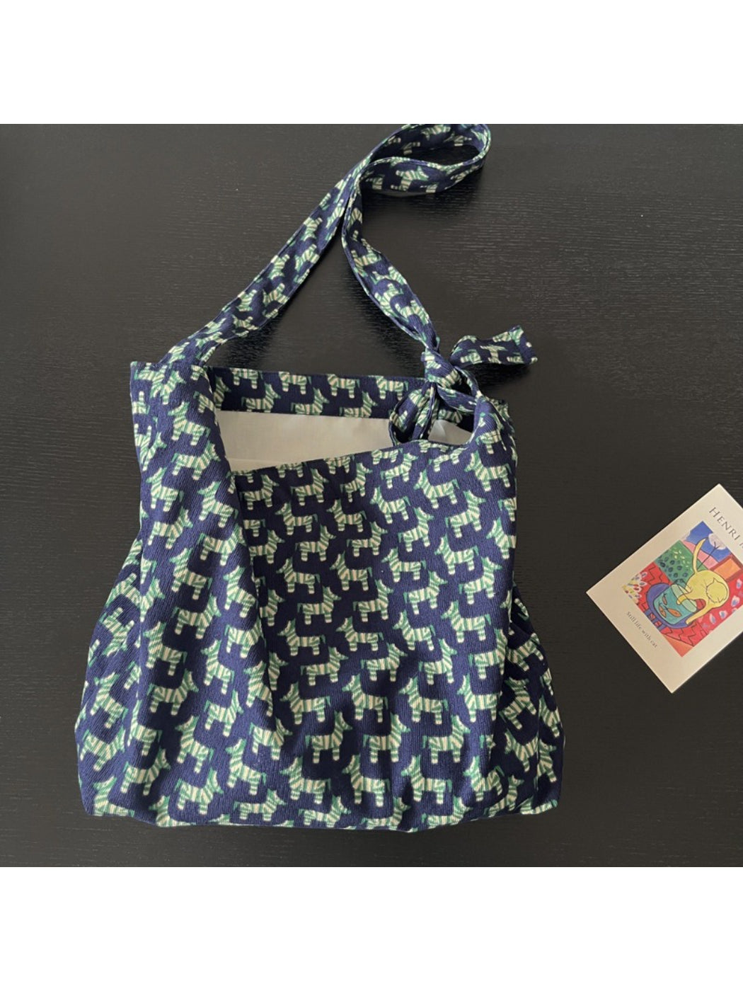 Model wearing Cosbai blue zebra print tie shoulder bag over shoulder